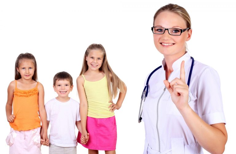 Healthcare professional standing with three young patients, gesturing number one with her finger.